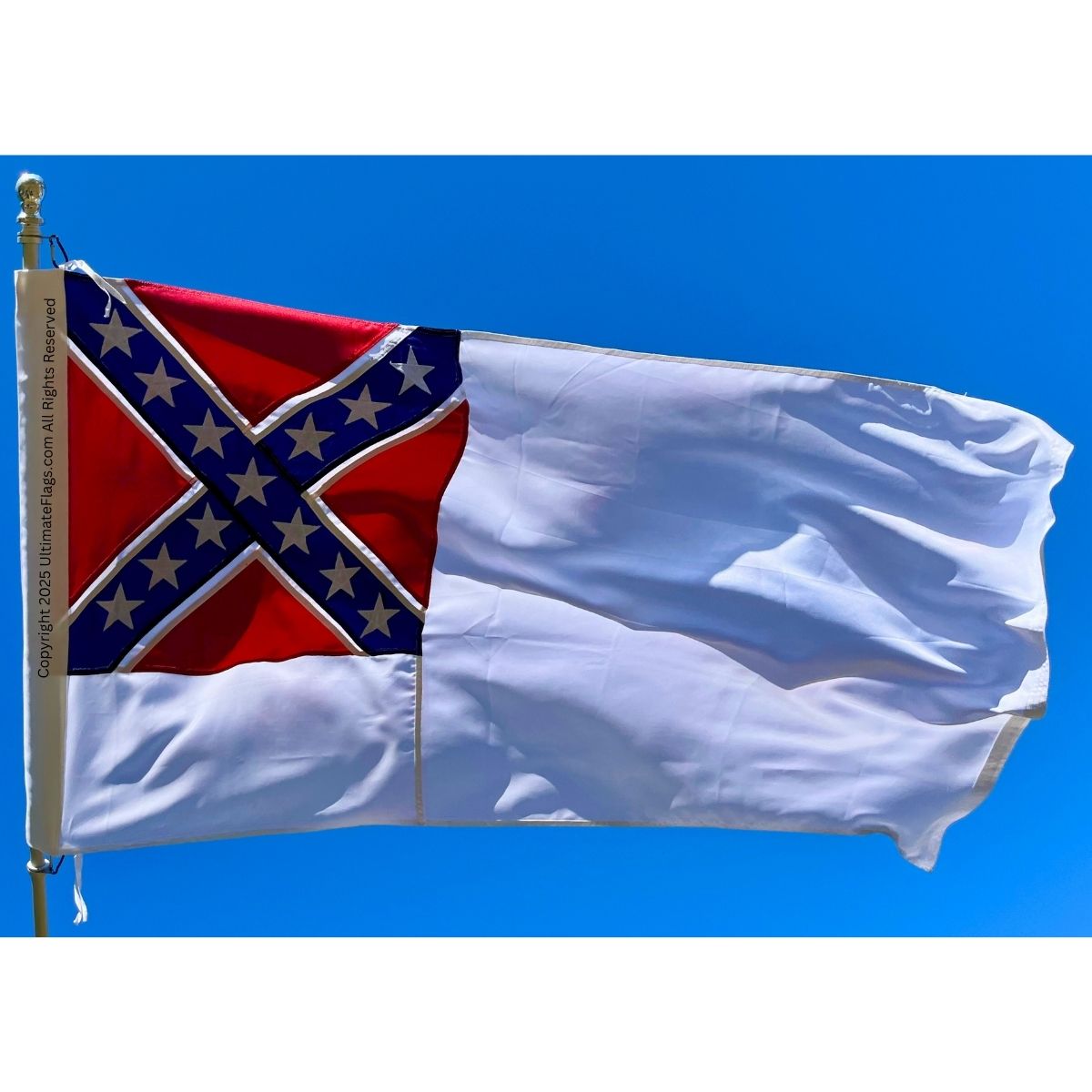 Confederate flag waving against a clear blue sky, symbolizing Southern heritage. Find cheap and affordable options for this design and other flags to buy online at UltimateFlags.com.