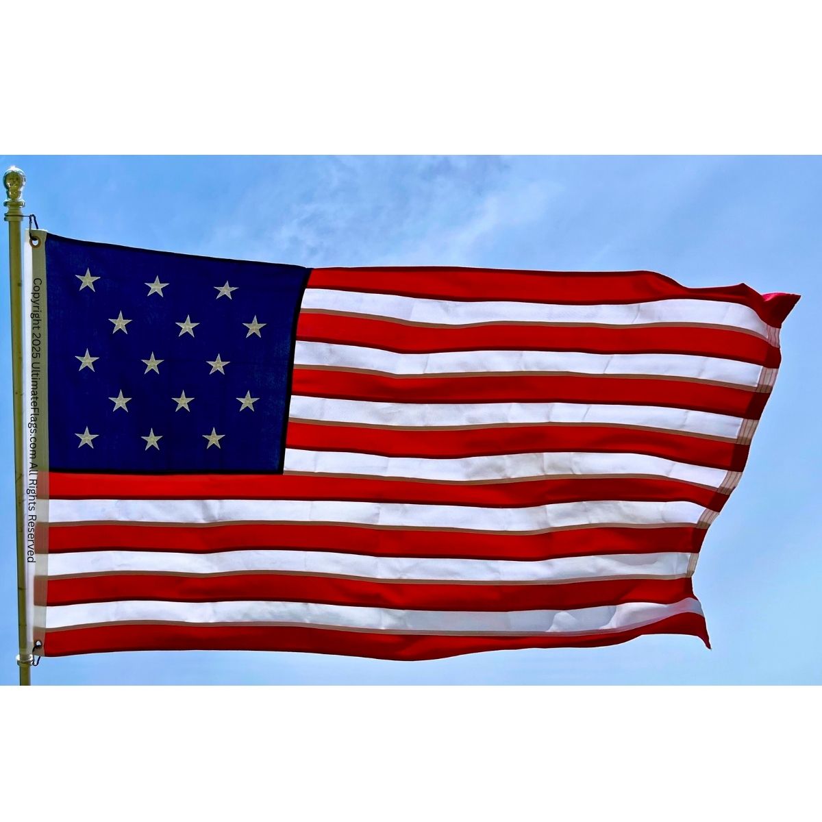 American flag waving against a blue sky, representing patriotism and national pride. Perfect for outdoor displays, events, or home decor. Buy affordable and high-quality American flags online at UltimateFlags.com.