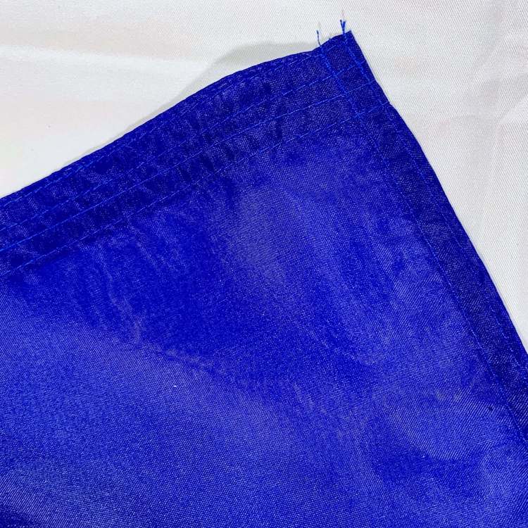 Vibrant blue flag showcasing durable fabric, ideal for outdoor use and events. Perfect for those seeking cheap and affordable options to buy online. Discover the best selection of flags at UltimateFlags.com.