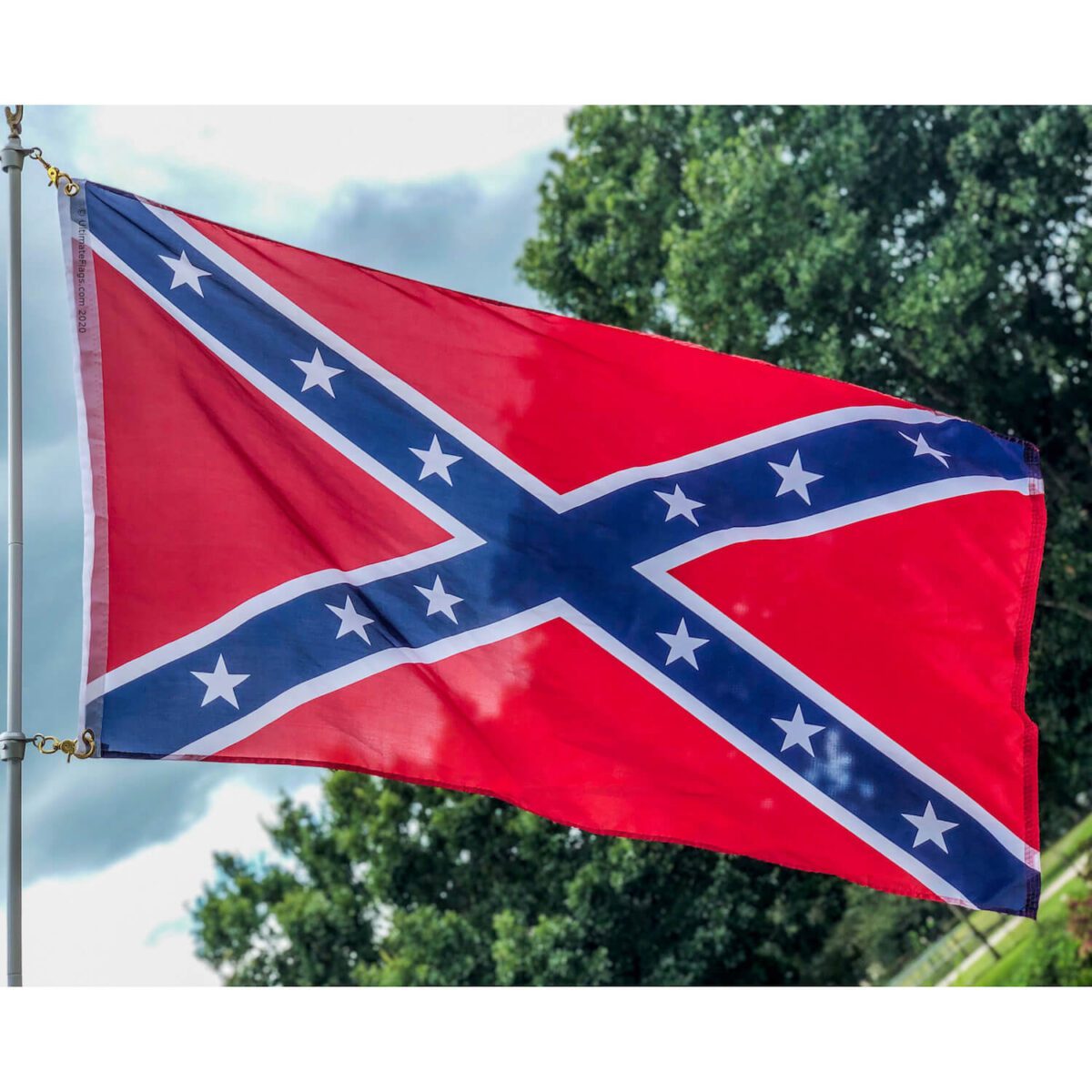 Confederate flag waving in the wind, showcasing vibrant colors and detailed design. Perfect for collectors and flag enthusiasts looking for cheap and affordable options. Buy online for the best deals at UltimateFlags.com.