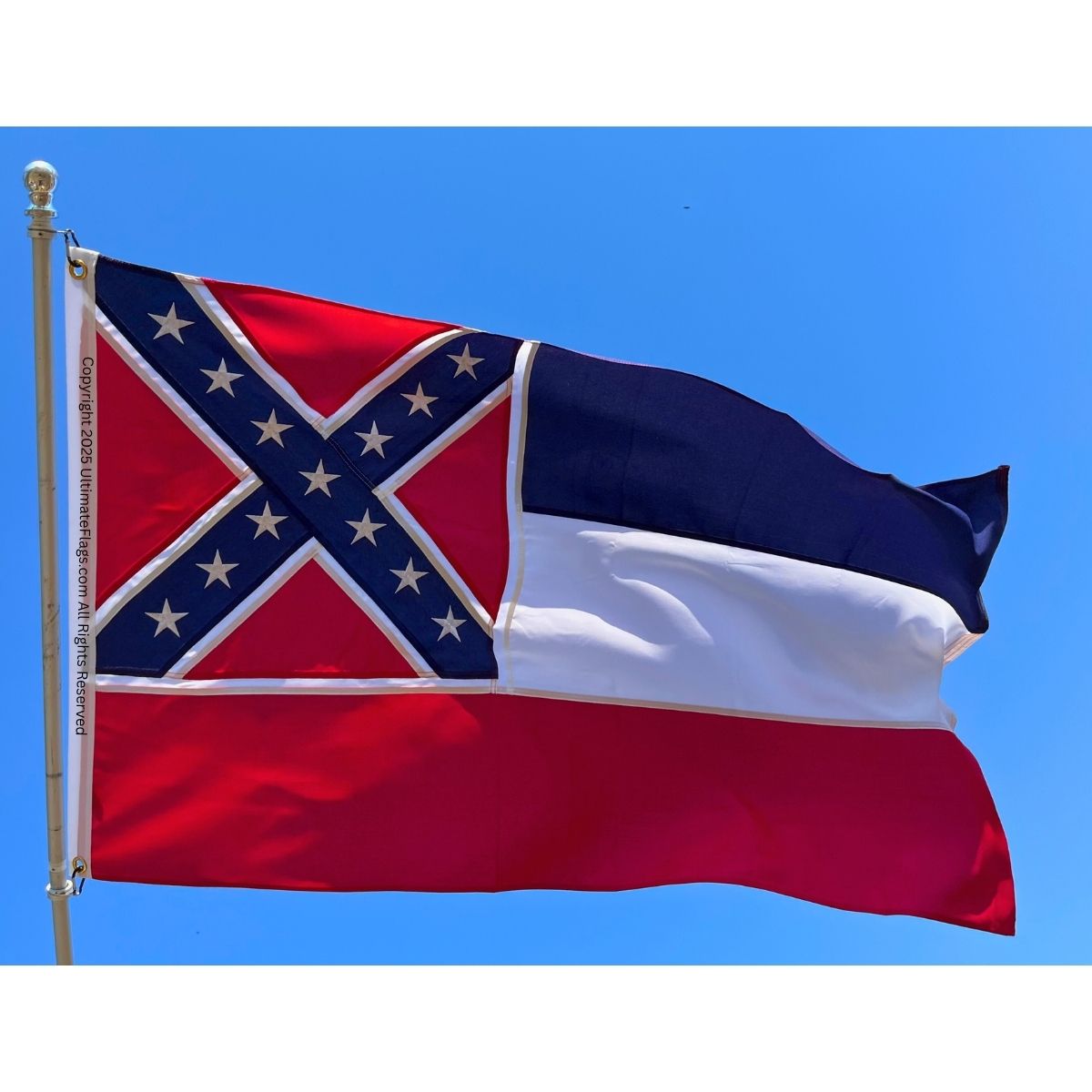 Mississippi state flag waving against a clear blue sky, showcasing its vibrant colors and design. This affordable flag is perfect for those looking to buy online the best quality flags. Shop now at UltimateFlags.com.