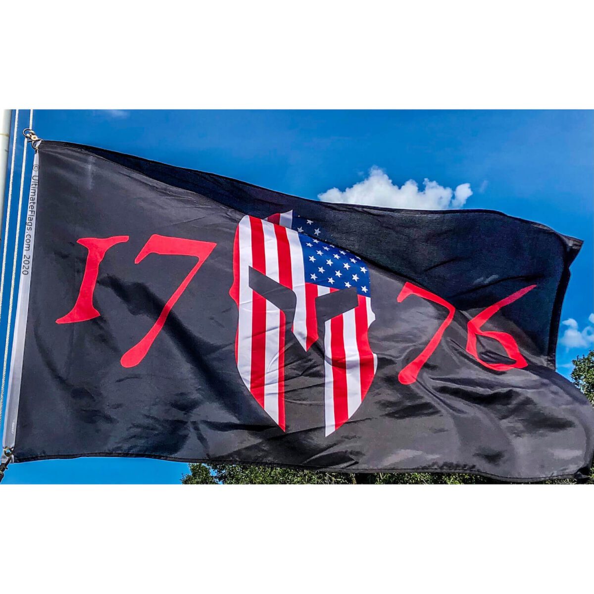 A striking flag featuring a Spartan helmet design with American flag elements and the numbers "1776," symbolizing patriotism and strength. This flag is perfect for those seeking a cheap and affordable way to showcase their American pride. Buy online at UltimateFlags.com for the best selection of flags.