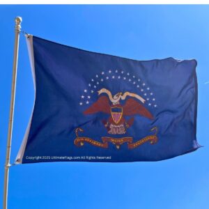 Pennsylvania state flag waving against a clear blue sky, symbolizing patriotism and state pride. This affordable flag is perfect for showcasing your love for Pennsylvania. Buy online at UltimateFlags.com for the best deals on flags.