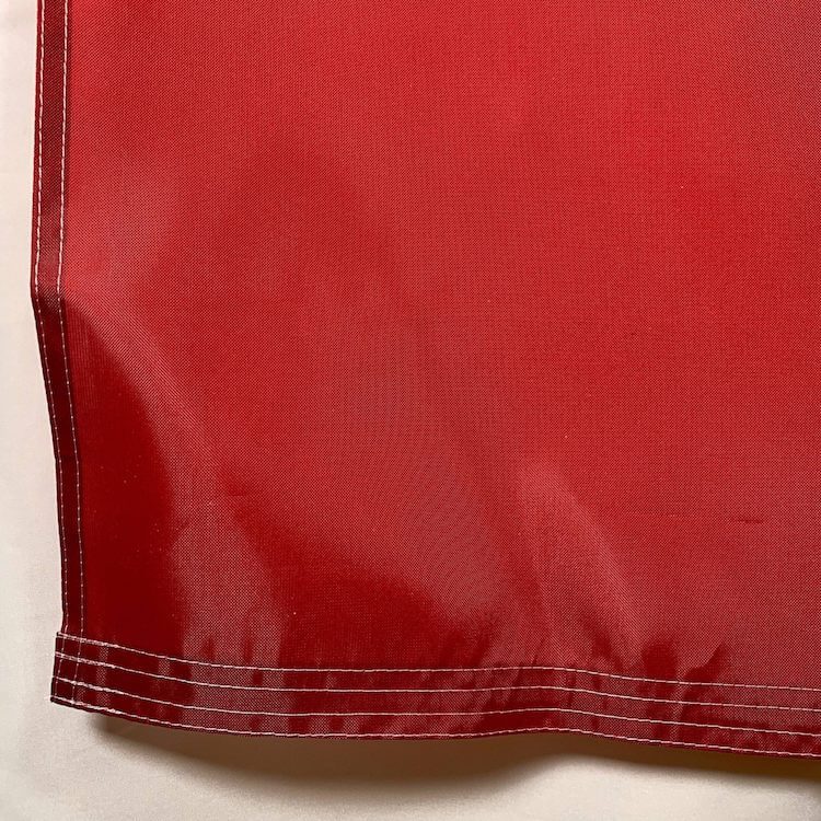 Durable red flag fabric with reinforced stitching, perfect for outdoor use. Ideal for events, promotions, or home decoration. Find the best deals on cheap and affordable flags to buy online at UltimateFlags.com.