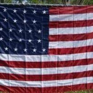 American flag displayed outdoors, showcasing vibrant colors and detailed stars and stripes. This affordable flag is perfect for patriotic celebrations and events. Buy online today for the best deals at UltimateFlags.com.