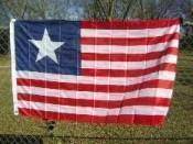 Liberian flag displayed outdoors, showcasing vibrant colors and design. Find cheap and affordable flags to buy online, including the best options for your needs. Visit UltimateFlags.com for more details.