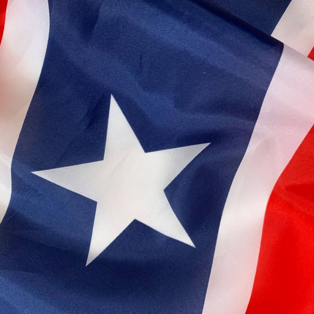 This image features a close-up of a vibrant flag with a prominent star design, showcasing its rich colors and intricate details. Perfect for those looking to buy online, this affordable and stylish flag is one of the best options available. Shop now at UltimateFlags.com.