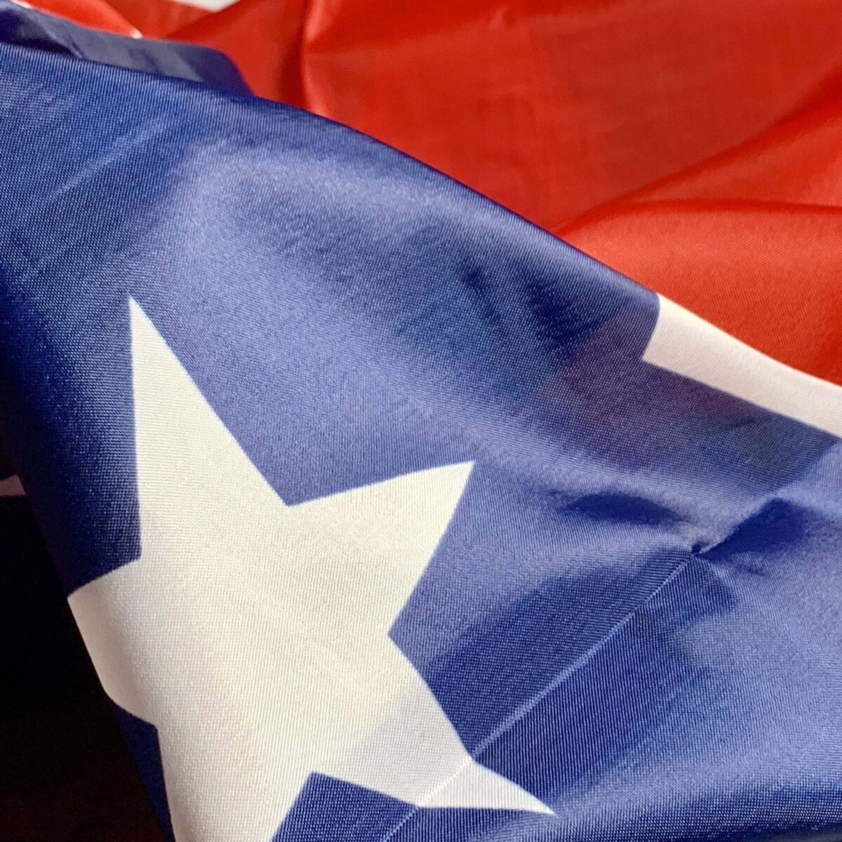 High-quality image of a vibrant flag featuring a blue field with white stars and a red background, perfect for patriotic displays. Ideal for those seeking cheap and affordable flags, this is one of the best options to buy online. Shop now at UltimateFlags.com.