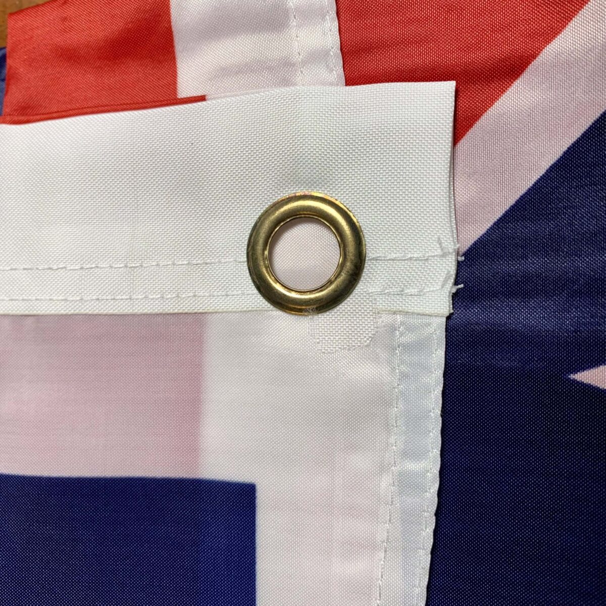 Close-up of the grommet on an Australian flag, showcasing its durable design for outdoor use. Buy affordable flags online at UltimateFlags.com for the best quality and value.