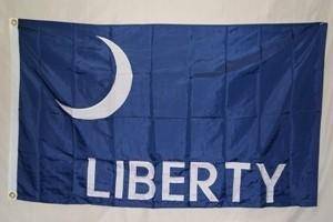 Blue flag featuring the word "LIBERTY" in bold white letters with a crescent moon design. This flag is a perfect choice for those seeking cheap and affordable options to showcase their love for freedom. Buy online now to get the best deals on quality flags at UltimateFlags.com.