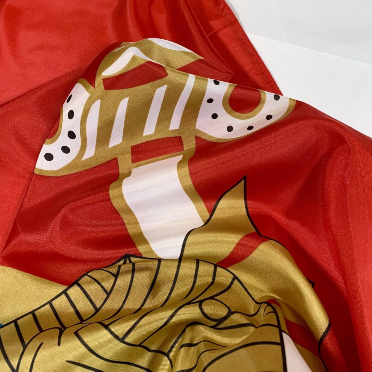 Vibrant red flag featuring intricate gold and white designs, perfect for adding a touch of elegance to any space. Ideal for those looking to buy online at affordable prices, this flag is the best choice for decoration or gifting. Find cheap options and more at UltimateFlags.com.