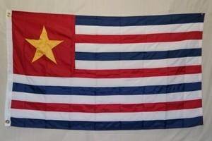 A vibrant flag featuring red and blue horizontal stripes with a prominent star, perfect for showcasing your patriotism. This affordable flag is the best choice for those looking to buy online. Find this and more at UltimateFlags.com.