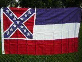 Mississippi state flag displayed on a fence, showcasing vibrant colors and distinct design elements. This affordable flag is perfect for those looking to buy online at the best prices. Check out UltimateFlags.com for more options.